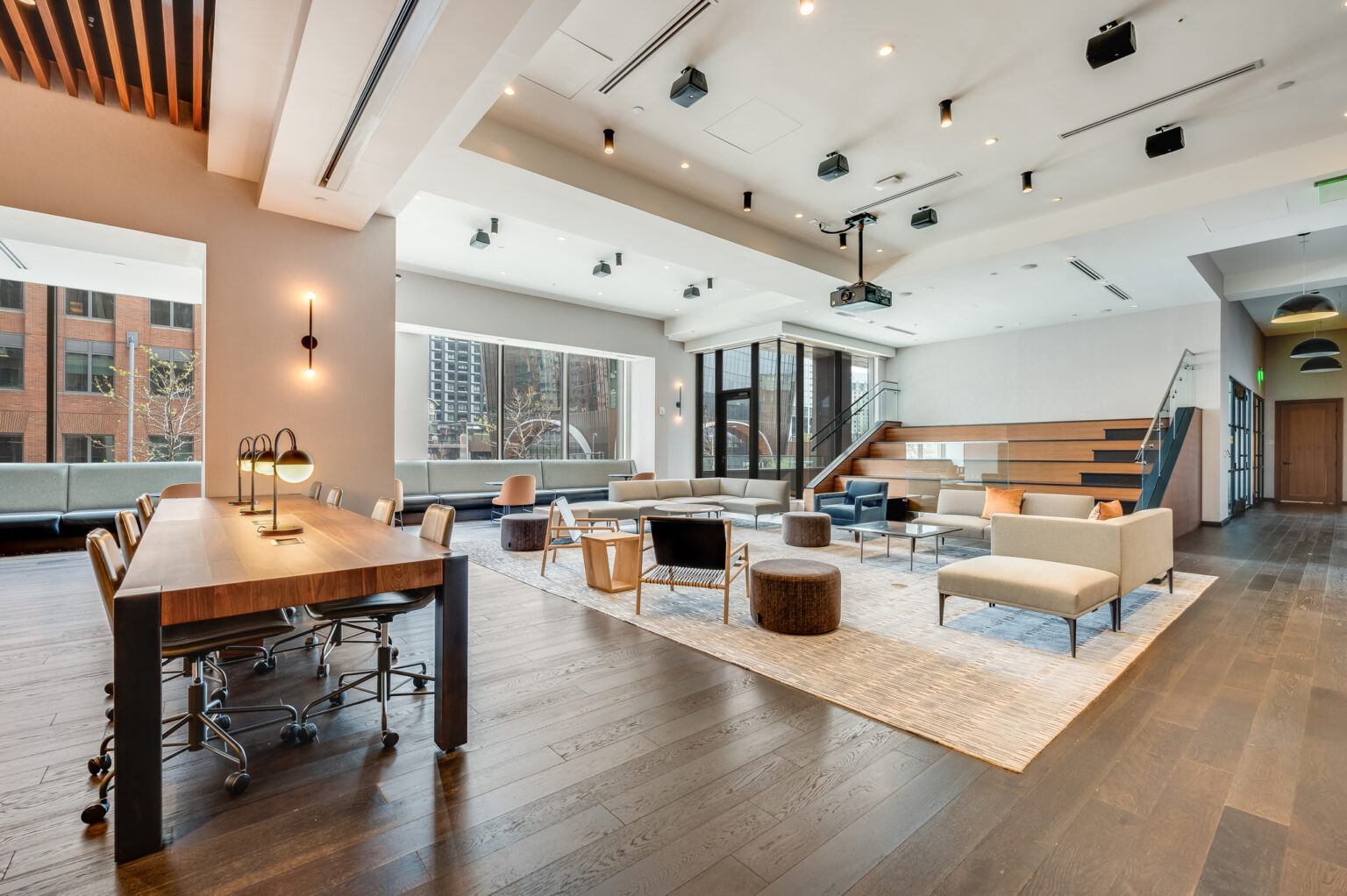 Open event floor at Echelon Innovation Center with lounge groupings and stairs to the mezzanine