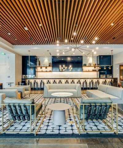 Bar and lounge seating beneath a starburst chandelier at Echelon Innovation Center