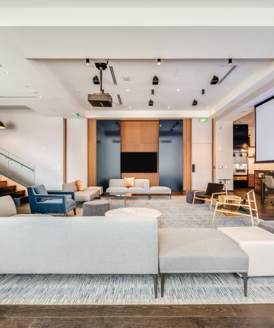 Presentation lounge at Echelon Innovation Center with a projection screen and soft seating